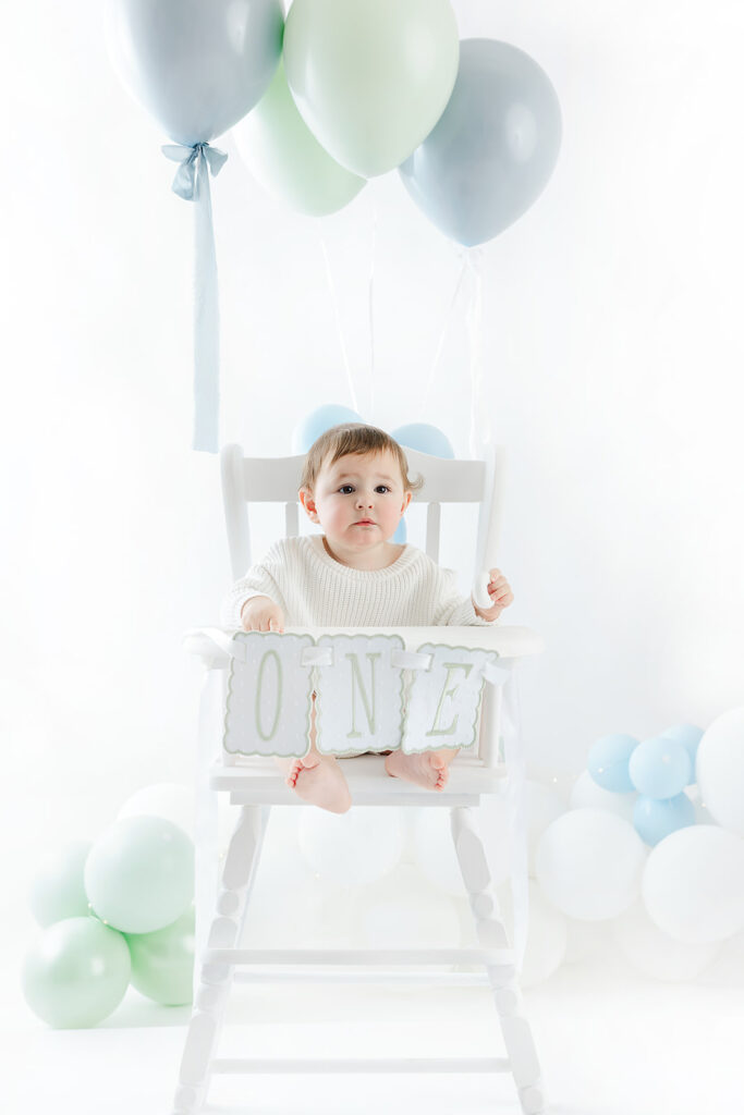 NYC first birthday photography, baby boy looking up at balloons cake topper Brooks, Heirloom by Melissa