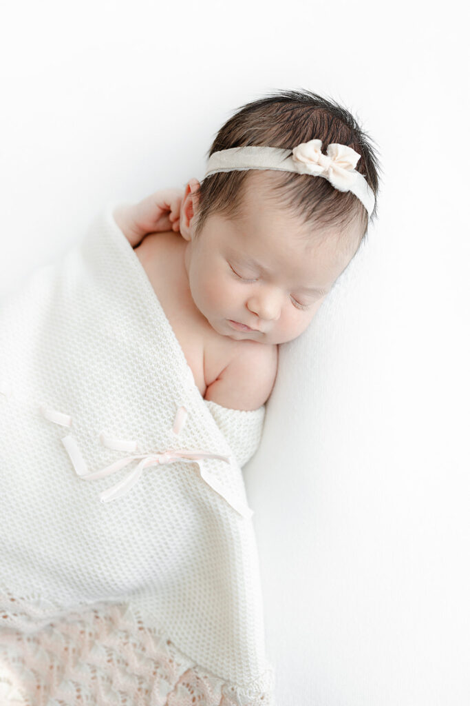 newborn baby girl sleeping in cream knit wrap, NYC newborn photographer, Heirloom by Melissa Photography