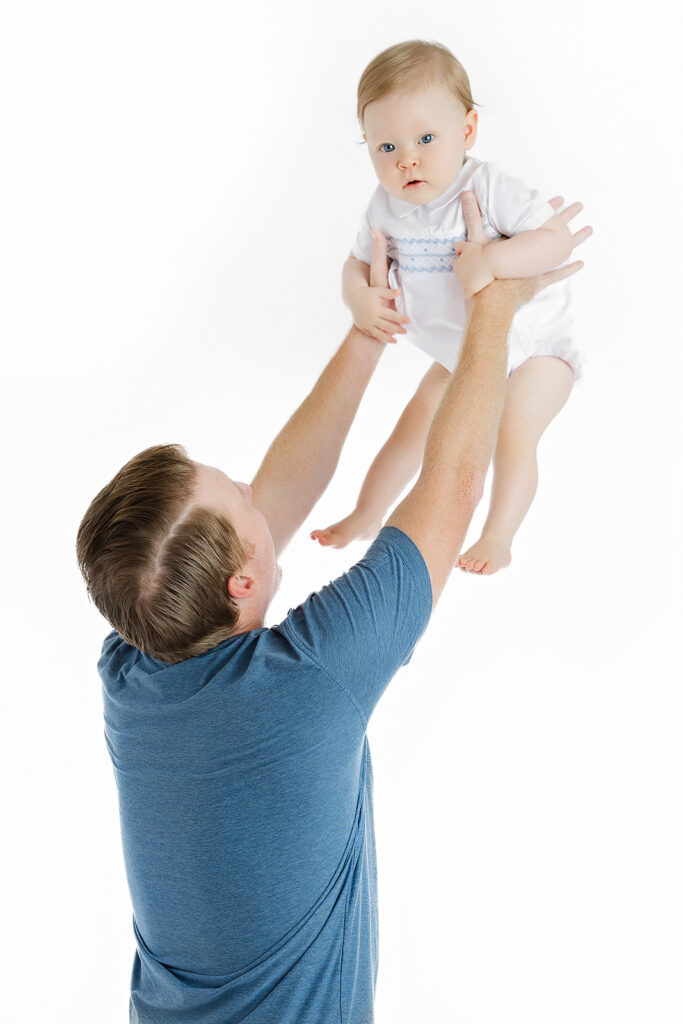 cake smash photoshoot NYC, dad lifting one year old baby boy, Heirloom by Melissa Photography Flatiron