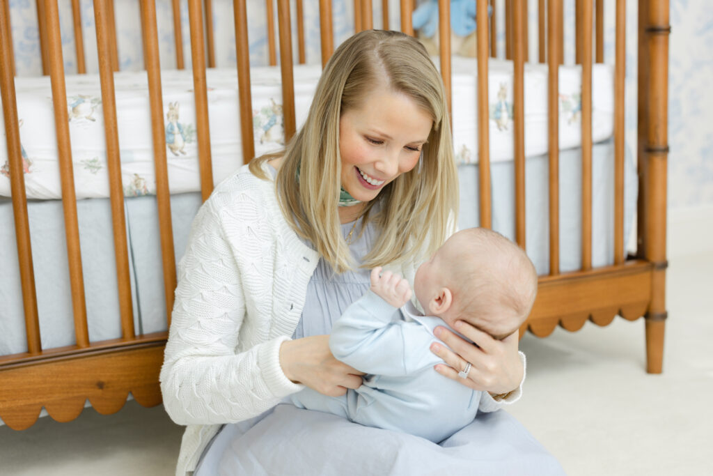 New parents holding newborn baby during timeless family photography session