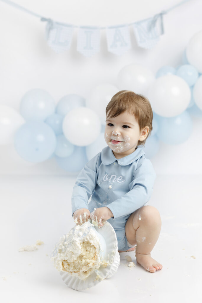 Scalloped ONE banner and blue ribbon cake documented during NYC cake smash photos at Heirloom by Melissa in Flatiron