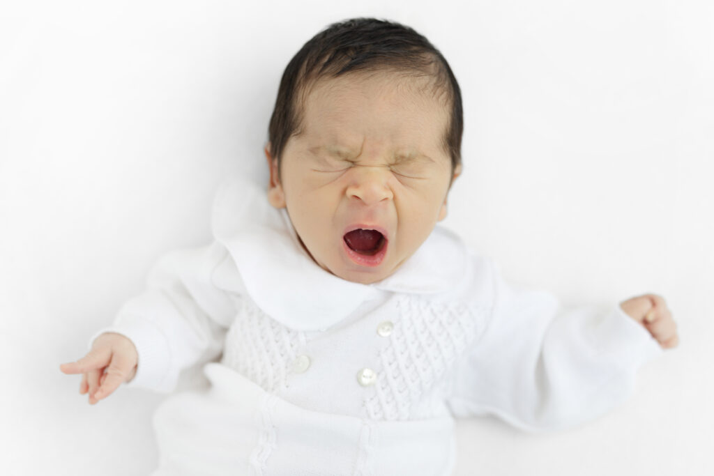 NYC studio newborn photographer newborn in white outfit