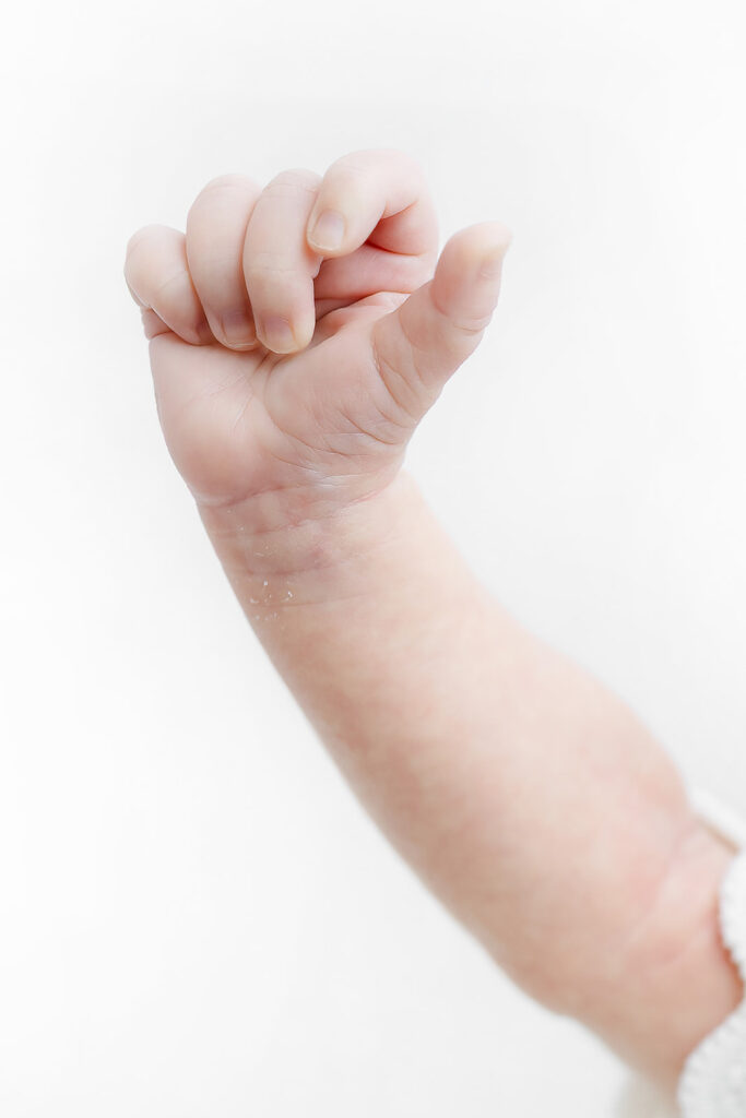 newborn baby girl tiny hand raised up, NYC newborn photography, Heirloom by Melissa Photography Manhattan