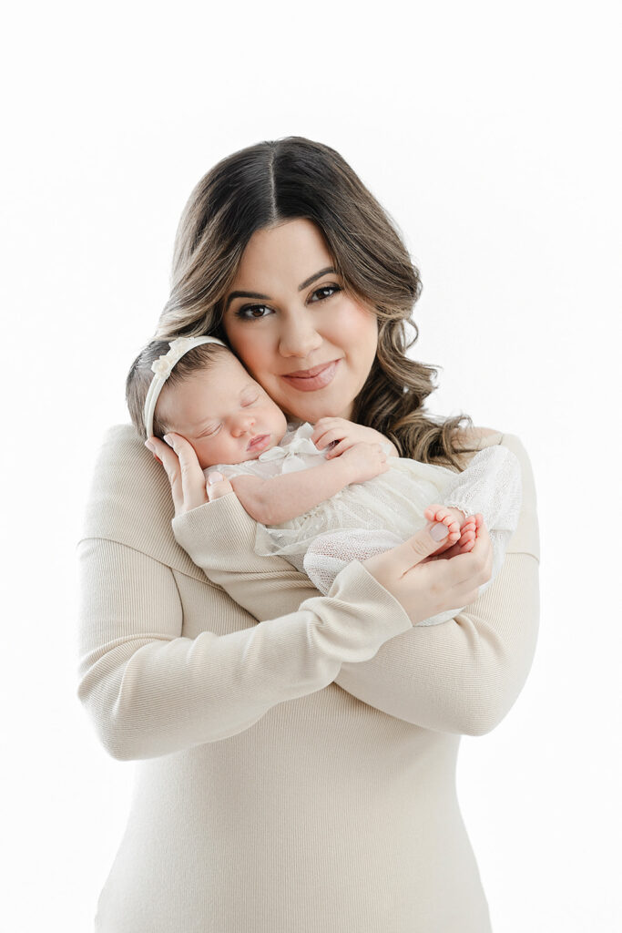 mom holding sleeping newborn baby girl against her cheek, NYC newborn photography, Heirloom by Melissa Flatiron studio