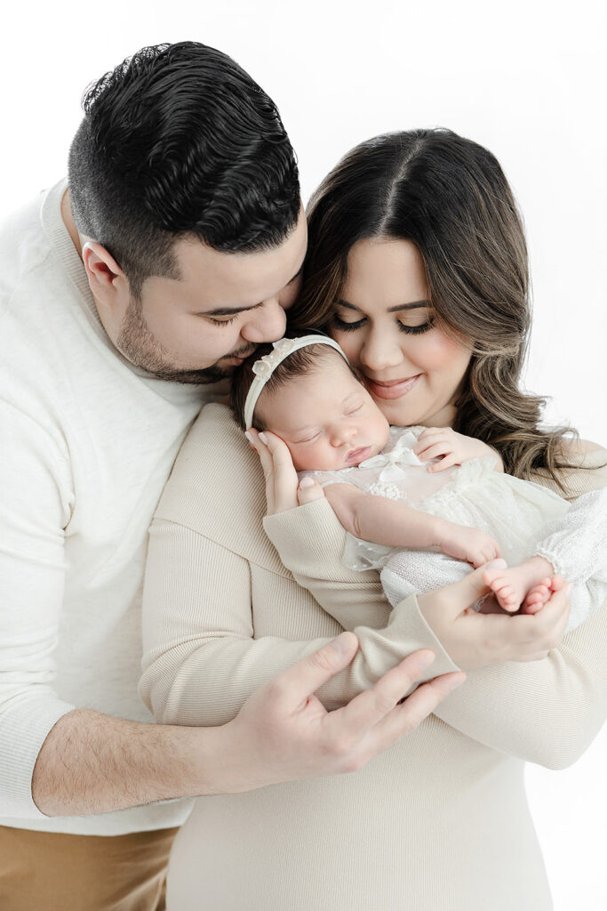 new parents leaning over sleeping newborn baby girl, NYC newborn photographer, Heirloom by Melissa Photography