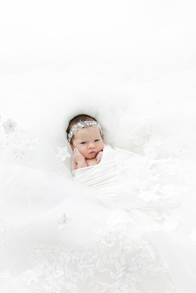 NYC newborn photographer, newborn baby girl sleeping in mother's wedding veil, Heirloom by Melissa Photography Flatiron studio