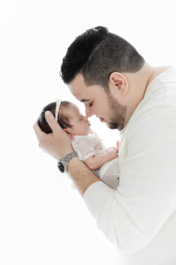 parents nose to nose over sleeping newborn, NYC newborn photographer, Heirloom by Melissa Photography Flatiron