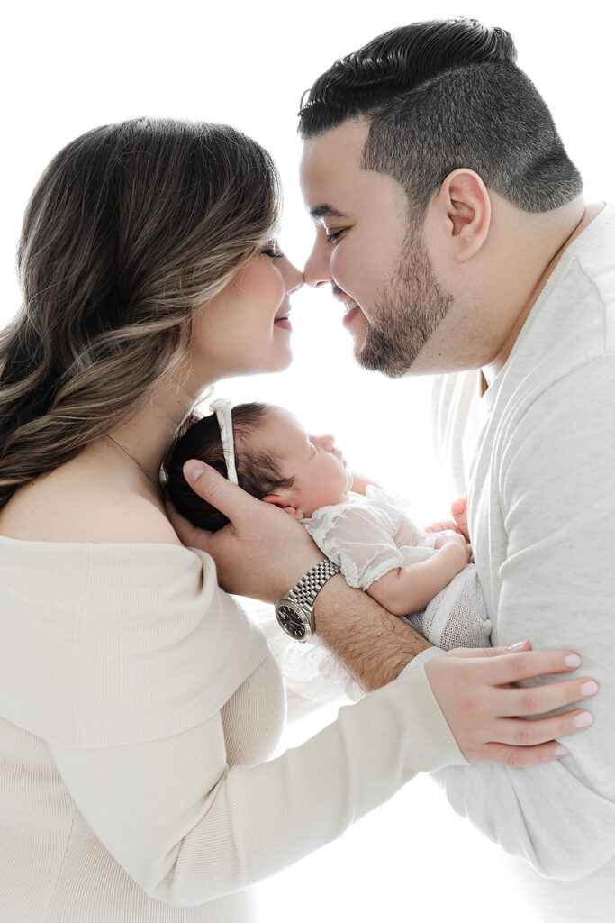mom and dad cradling newborn baby girl side profile, NYC newborn photography, Heirloom by Melissa Photography Flatiron