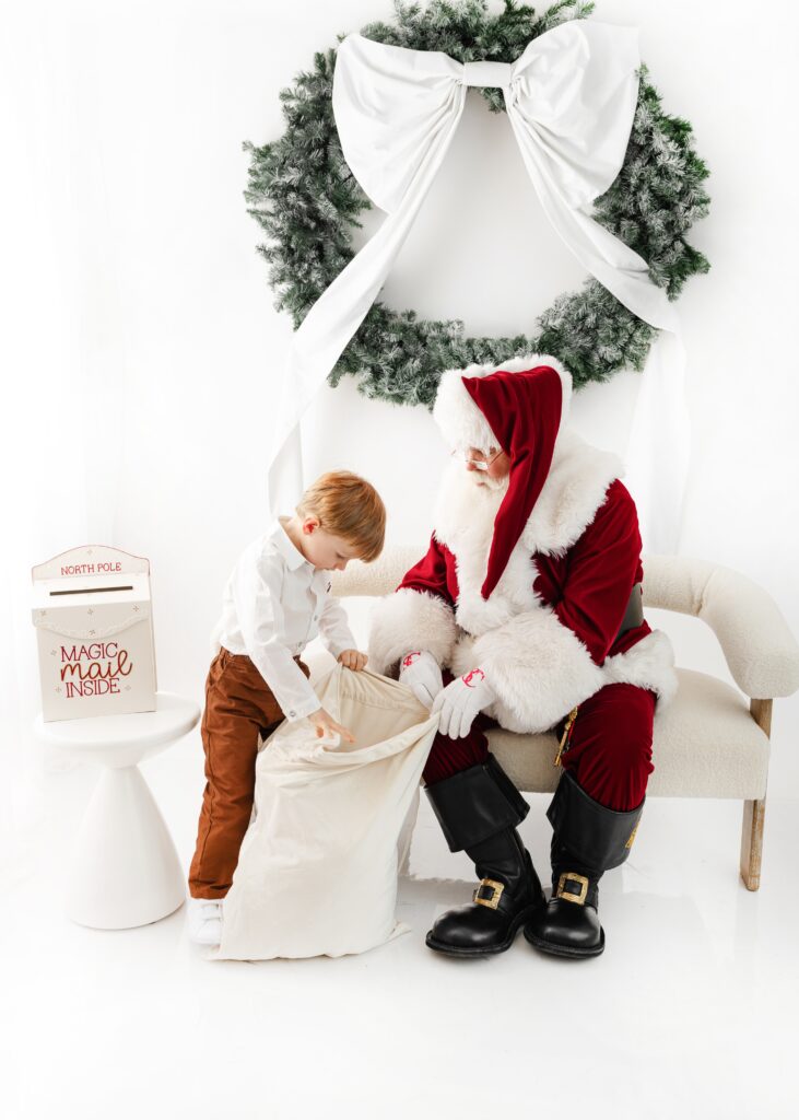 Child meeting Santa during holiday family portraits session in Manhattan
