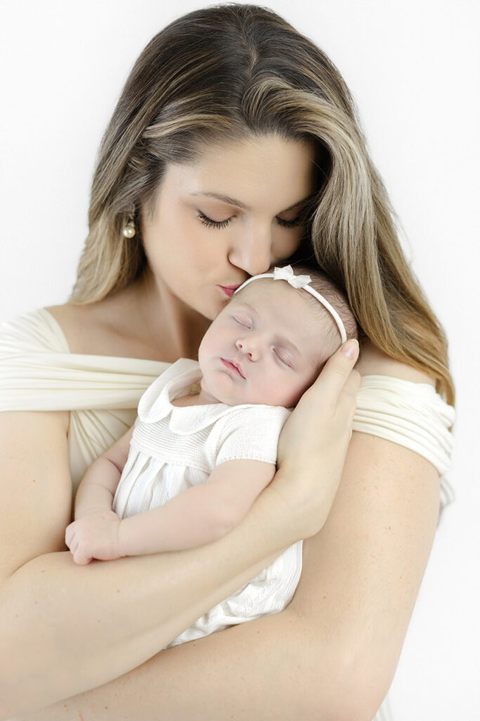 Flatiron newborn photographer, mom smiling with her newborn daughter at Heirloom by Melissa, Manhattan