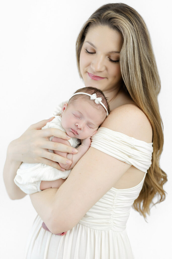 Flatiron newborn photographer, parents holding their sleeping newborn at Heirloom by Melissa, NYC