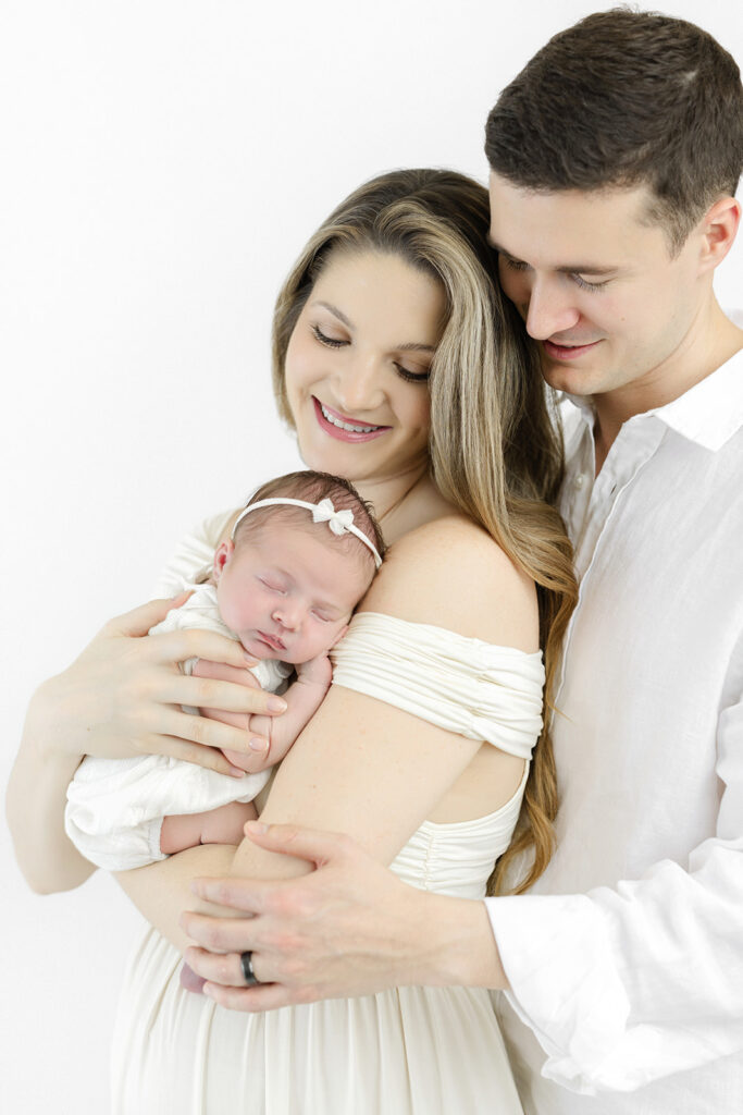 Flatiron newborn photographer, parents holding their newborn daughter at Heirloom by Melissa, Manhattan