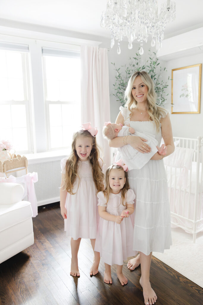 Family in nursery with chandelier, in-home session by New York newborn photographer Heirloom by Melissa