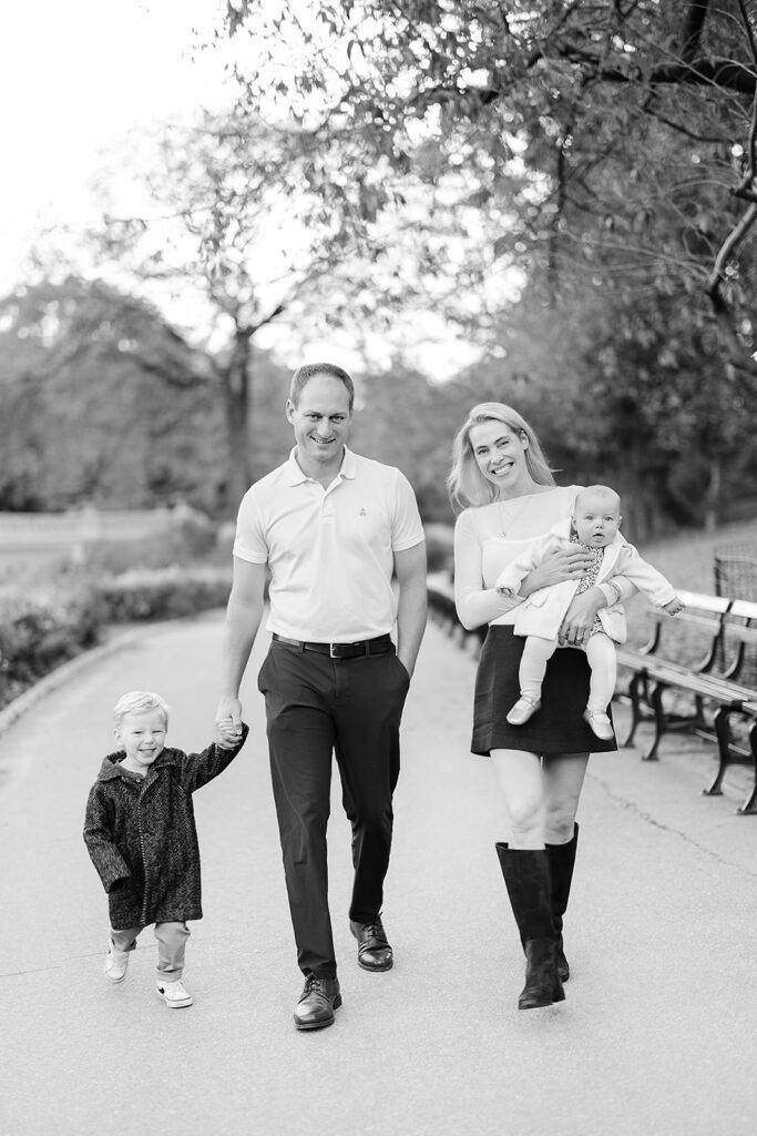 Family walking past Bethesda Fountain at golden hour with their dog, NYC family photographer Heirloom by Melissa Photography