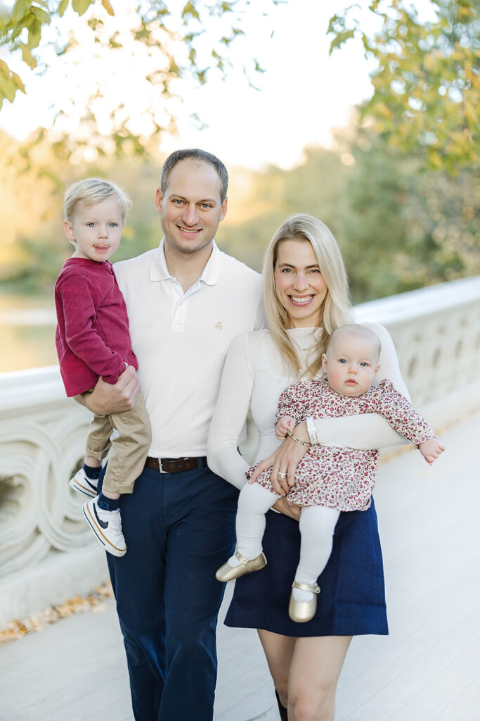 Toddler brother and baby sister in coordinating burgundy outfits in Central Park, NYC family photographer Heirloom by Melissa Photography