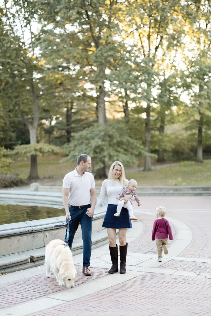 Family of four standing near Bethesda Fountain during a fall session with an NYC family photographer, Central Park, Heirloom by Melissa Photography