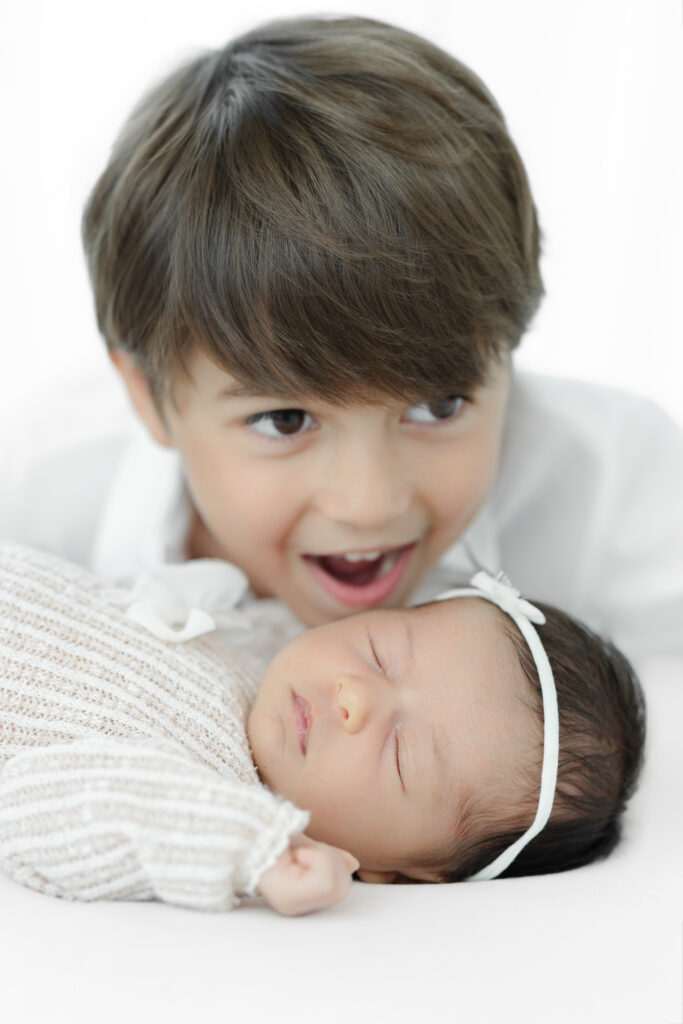Excited big brother meeting newborn sister