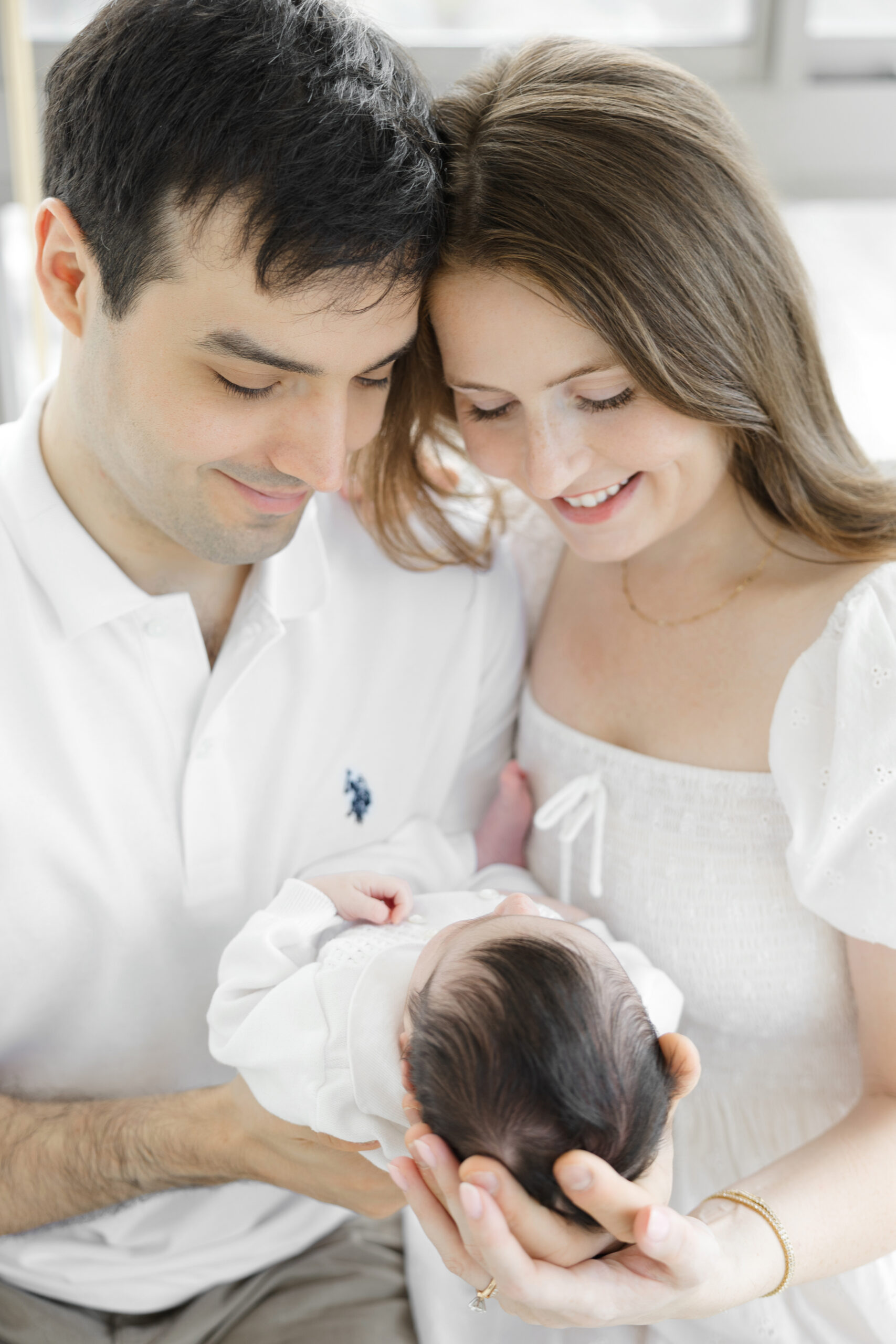 Parents holding her newborn baby during an in-home newborn session in the upper west side, nyc
