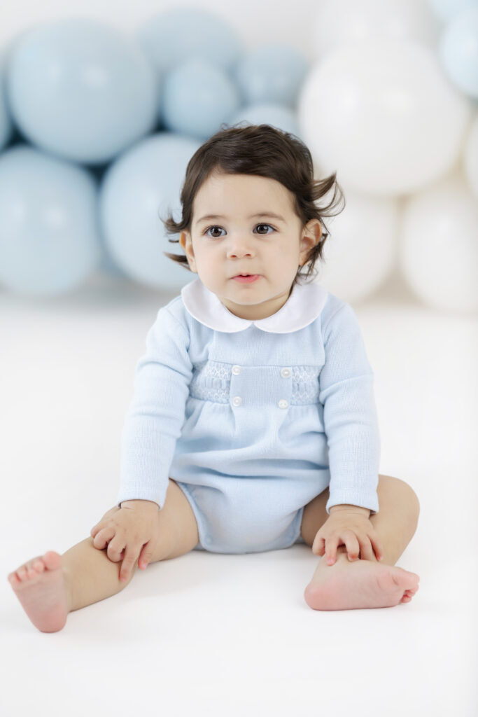 Soren sitting on the studio floor during his first birthday portraits