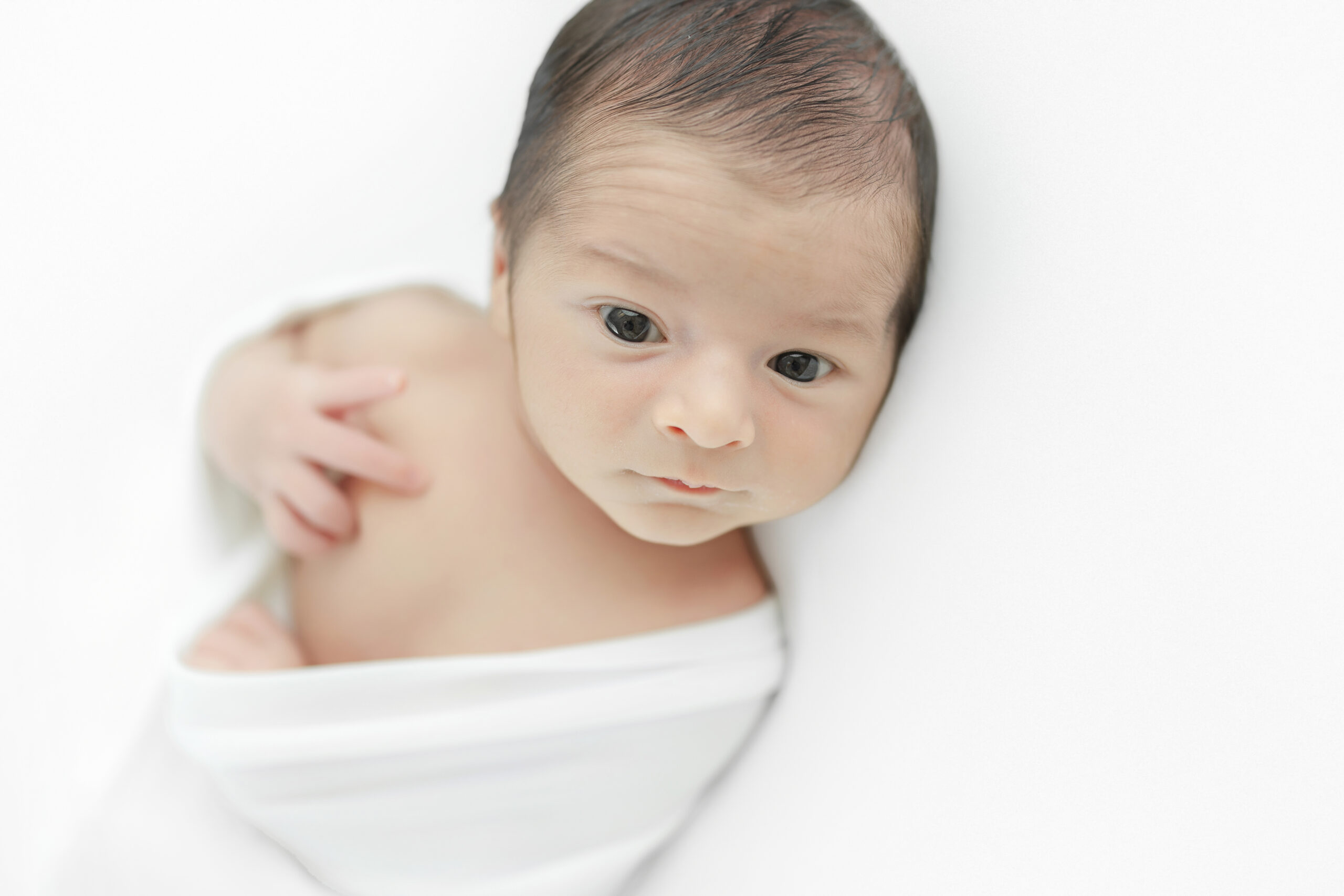 Awake newborn baby in his photography session