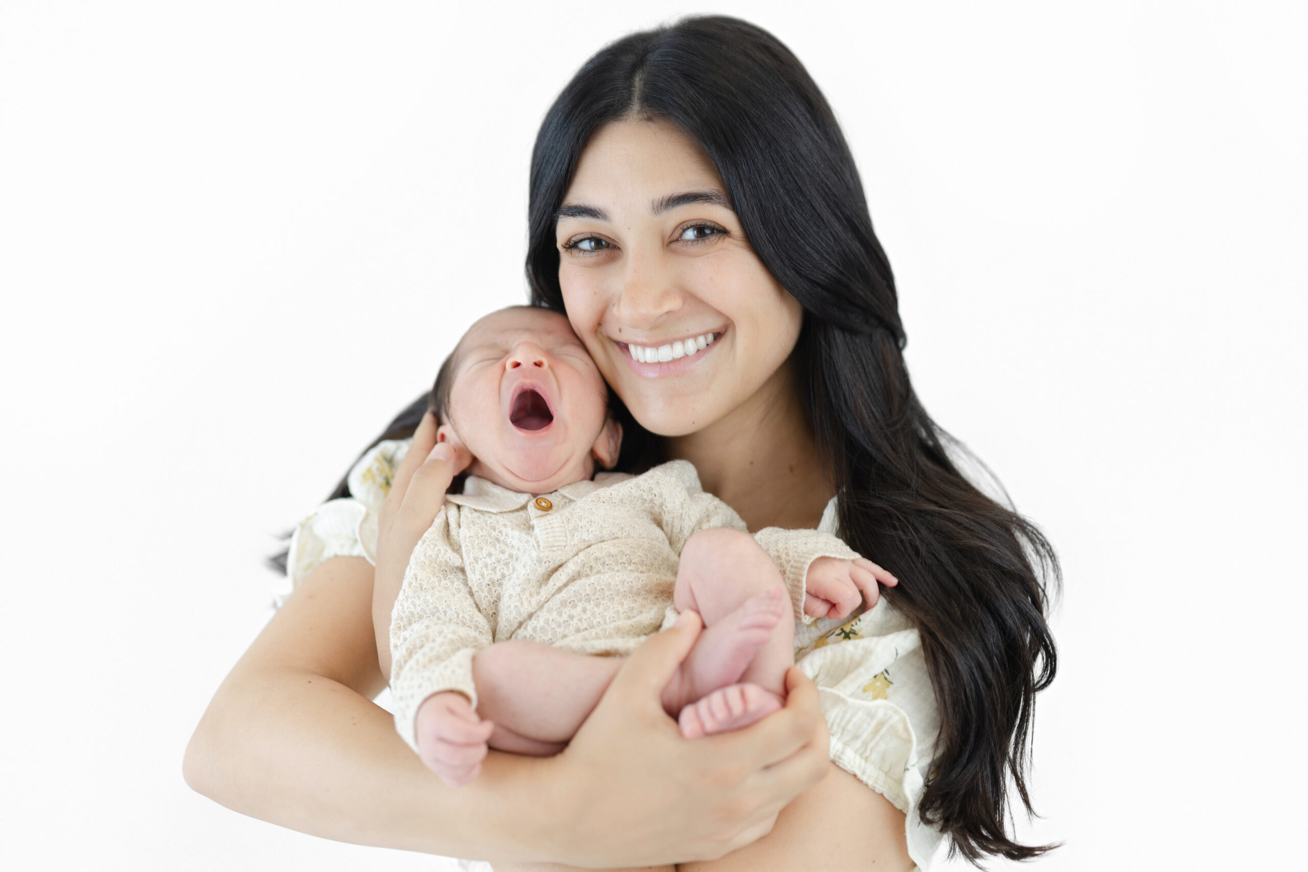 Baby boy yawning in a beige knit outfit during his NYC studio newborn session