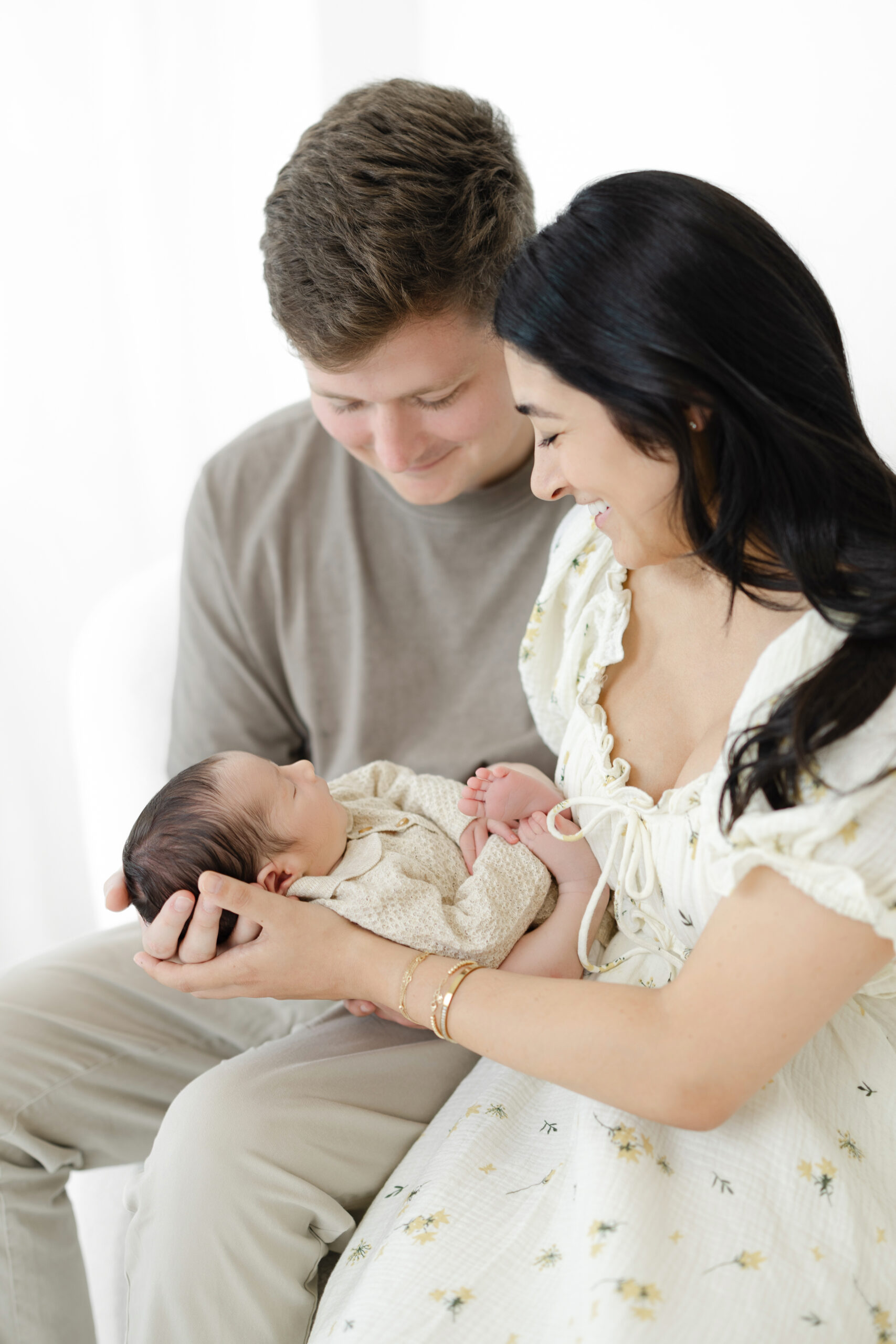 Parents holding their baby boy during a newborn photography session in NYC