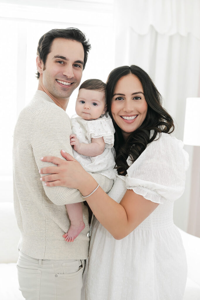 Baby girl looking toward the camera during her three-month milestone photos in NYC
