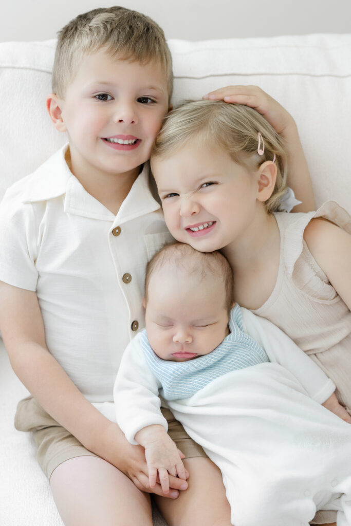 Three siblings together during an in-home newborn session