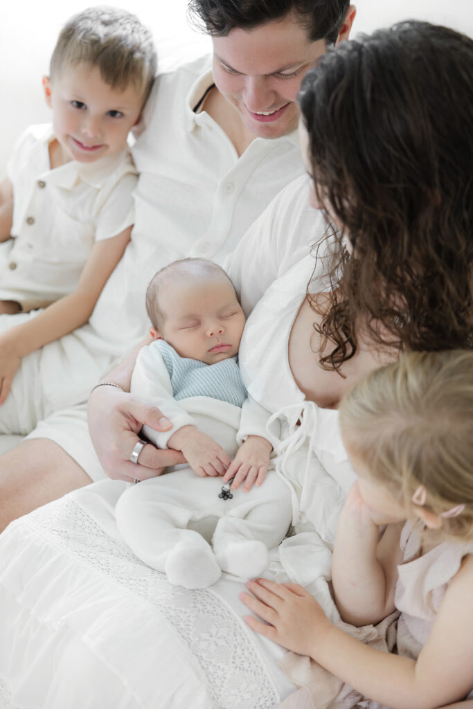 Parents and three children during a newborn photography session