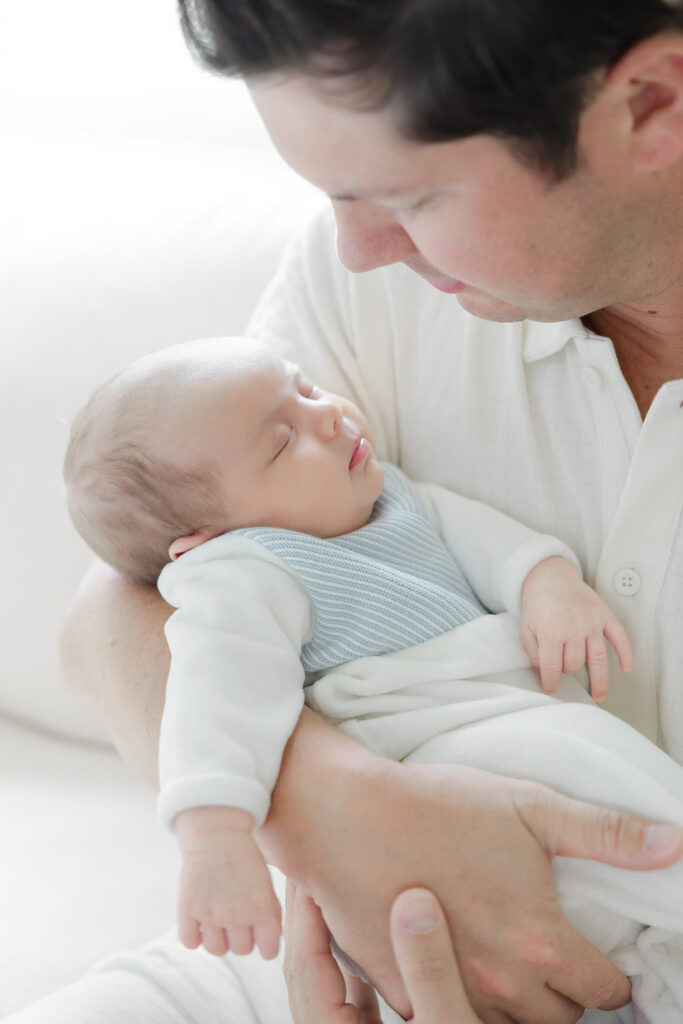 Newborn baby wearing a pale blue Feltman Brothers outfit