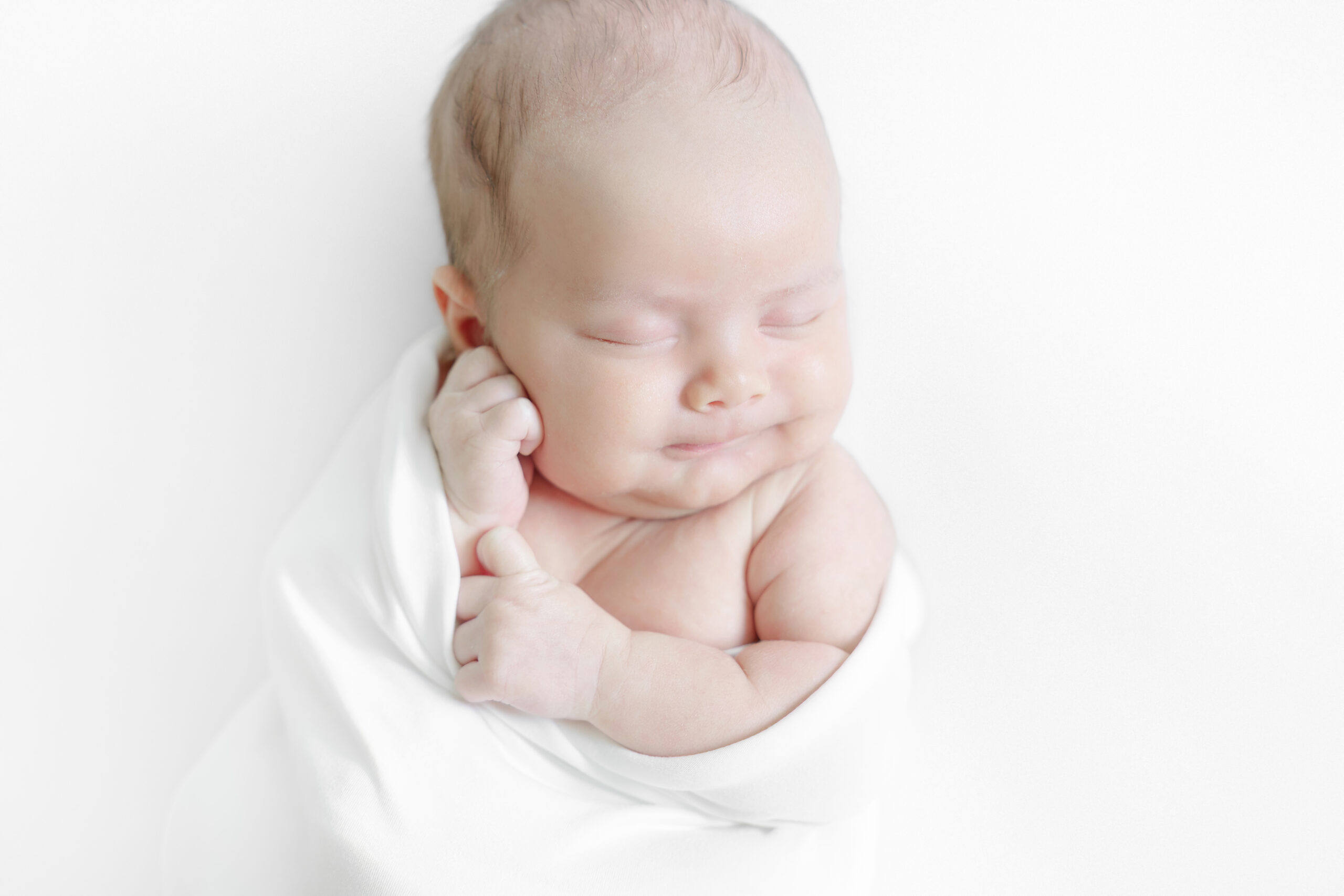 Individual newborn portrait photographed with natural window light