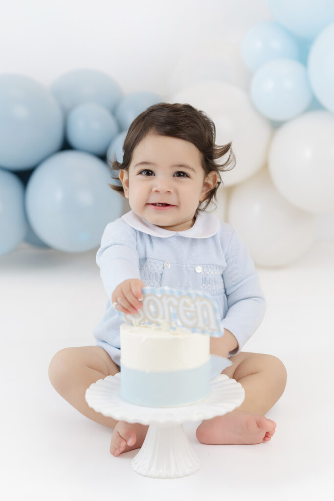 Soren crawling beside his birthday cake at the NYC studio
