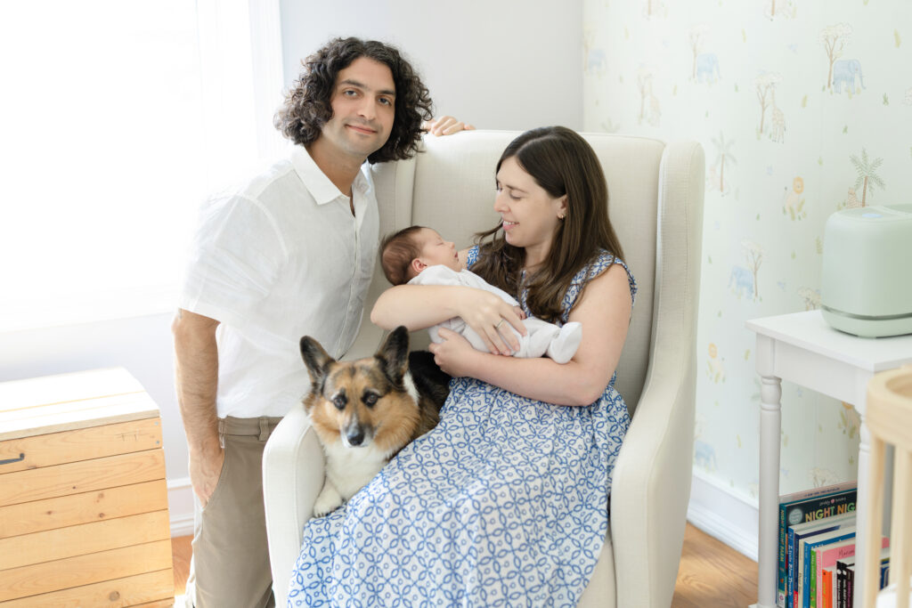 Parents and corgi together in the nursery during a Brooklyn in-home newborn session