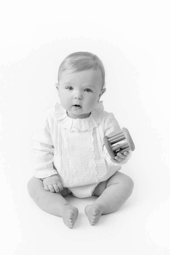 Black-and-white baby milestone portrait from an NYC first birthday photography session