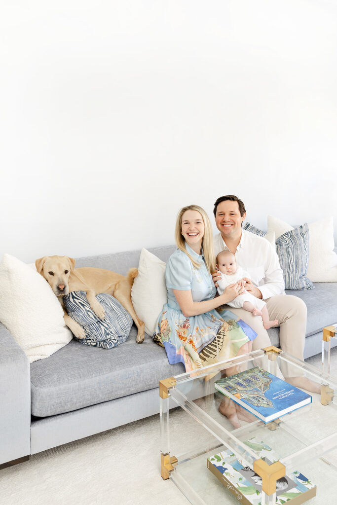 Parents holding their baby girl beside their Labrador during an Upper East Side newborn session