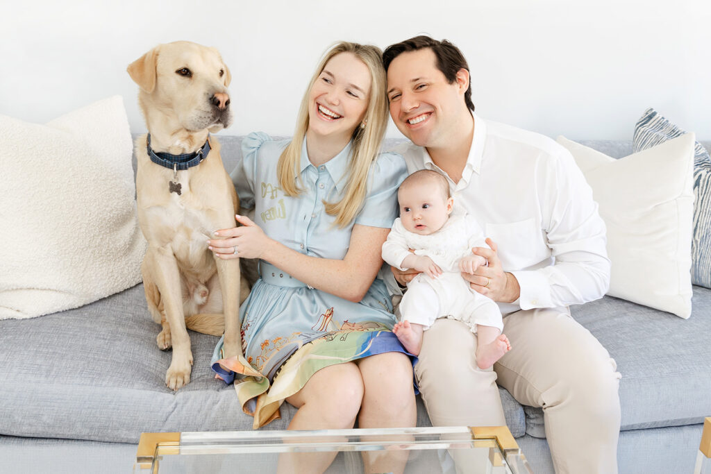 Parents with their nursing baby and Labrador during a relaxed Upper East Side newborn session