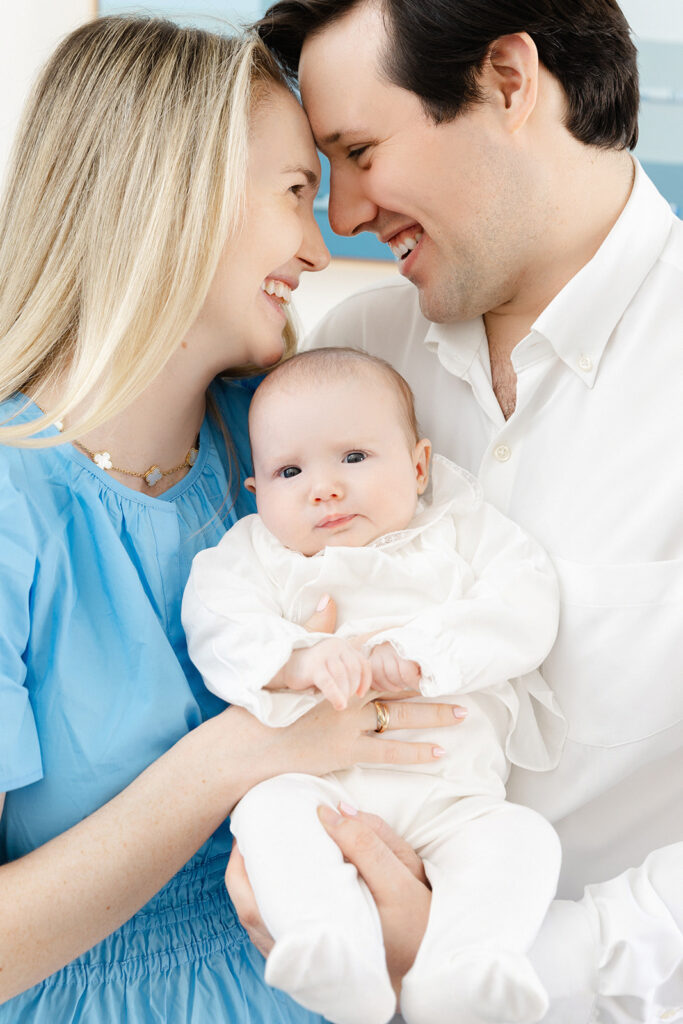 Mother and father holding their baby girl during Manhattan in-home newborn photography